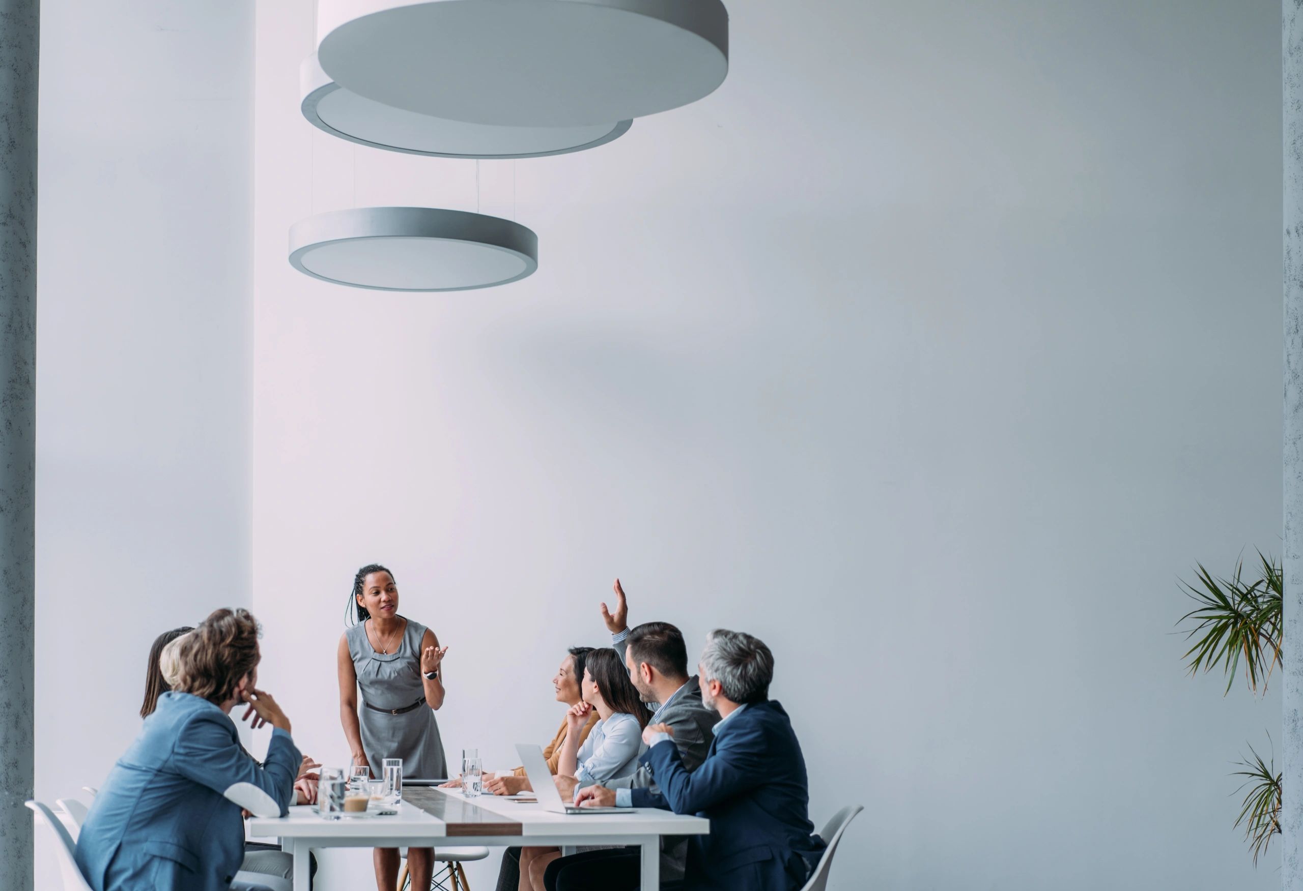 Businesswoman presenting to a leadership team in a board room