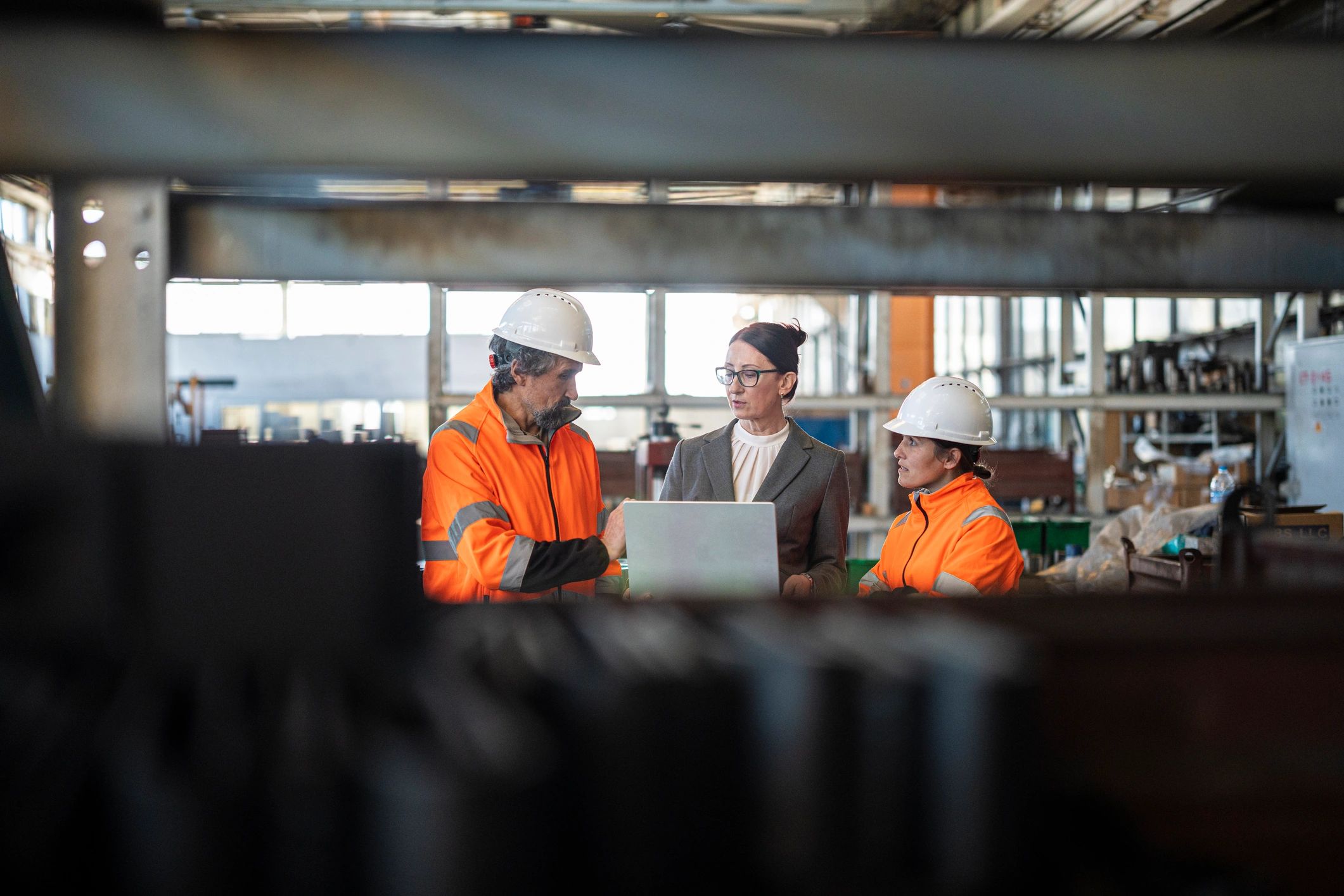 Manufacturing team discussing operations on the factory floor